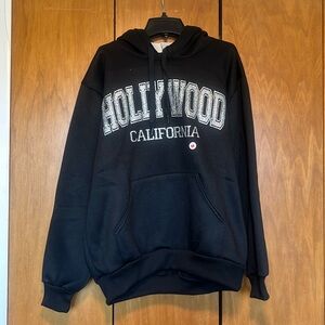 Never worn with tags. Hollywood California hoodie with glitter decal.